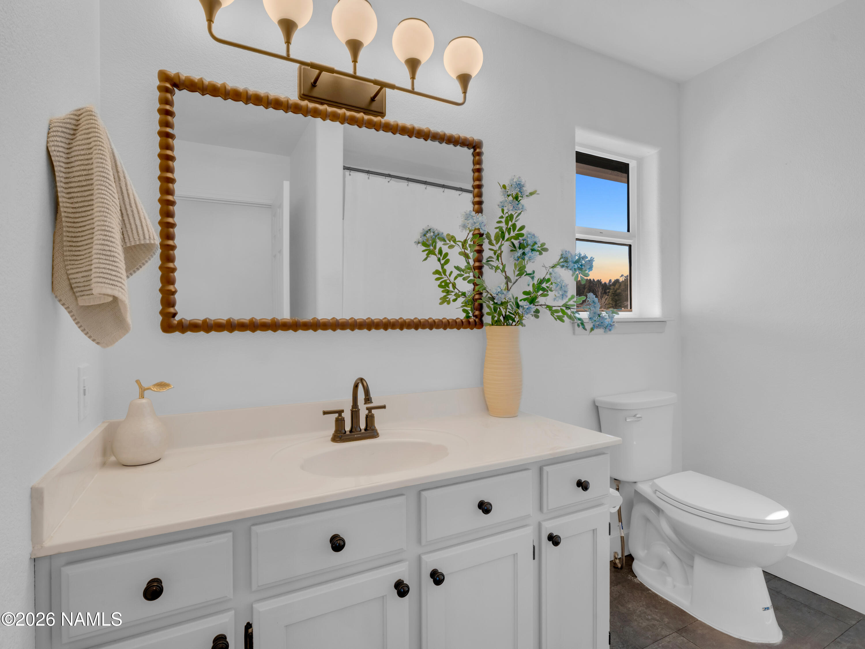 8115 Fawn Run Road Flagstaff, AZ 86004 - Photo 17 of 26 a bathroom with a toilet sink and mirror