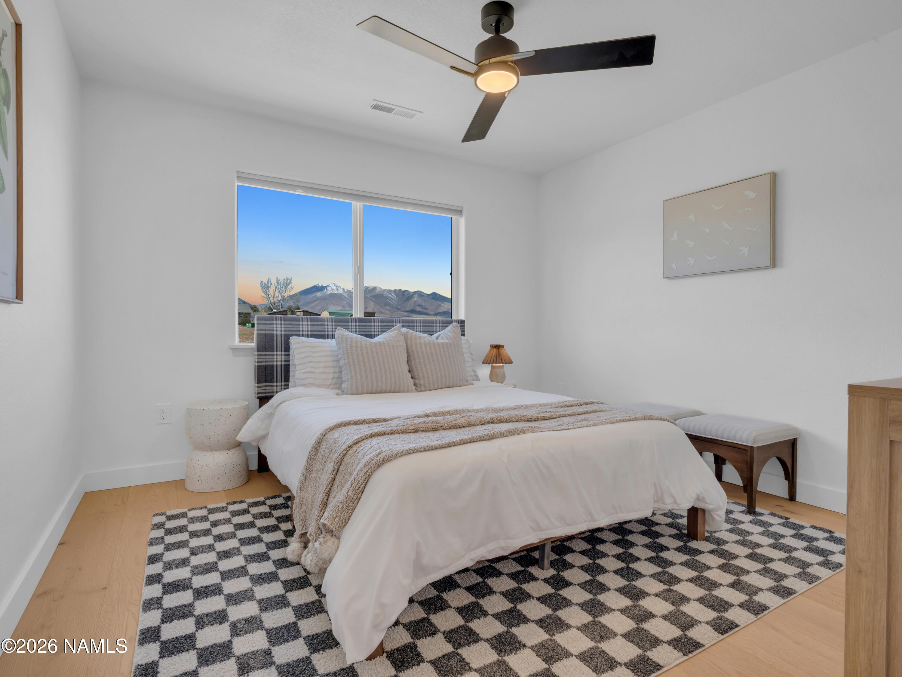 8115 Fawn Run Road Flagstaff, AZ 86004 - Photo 18 of 26 a bedroom with a bed and a table
