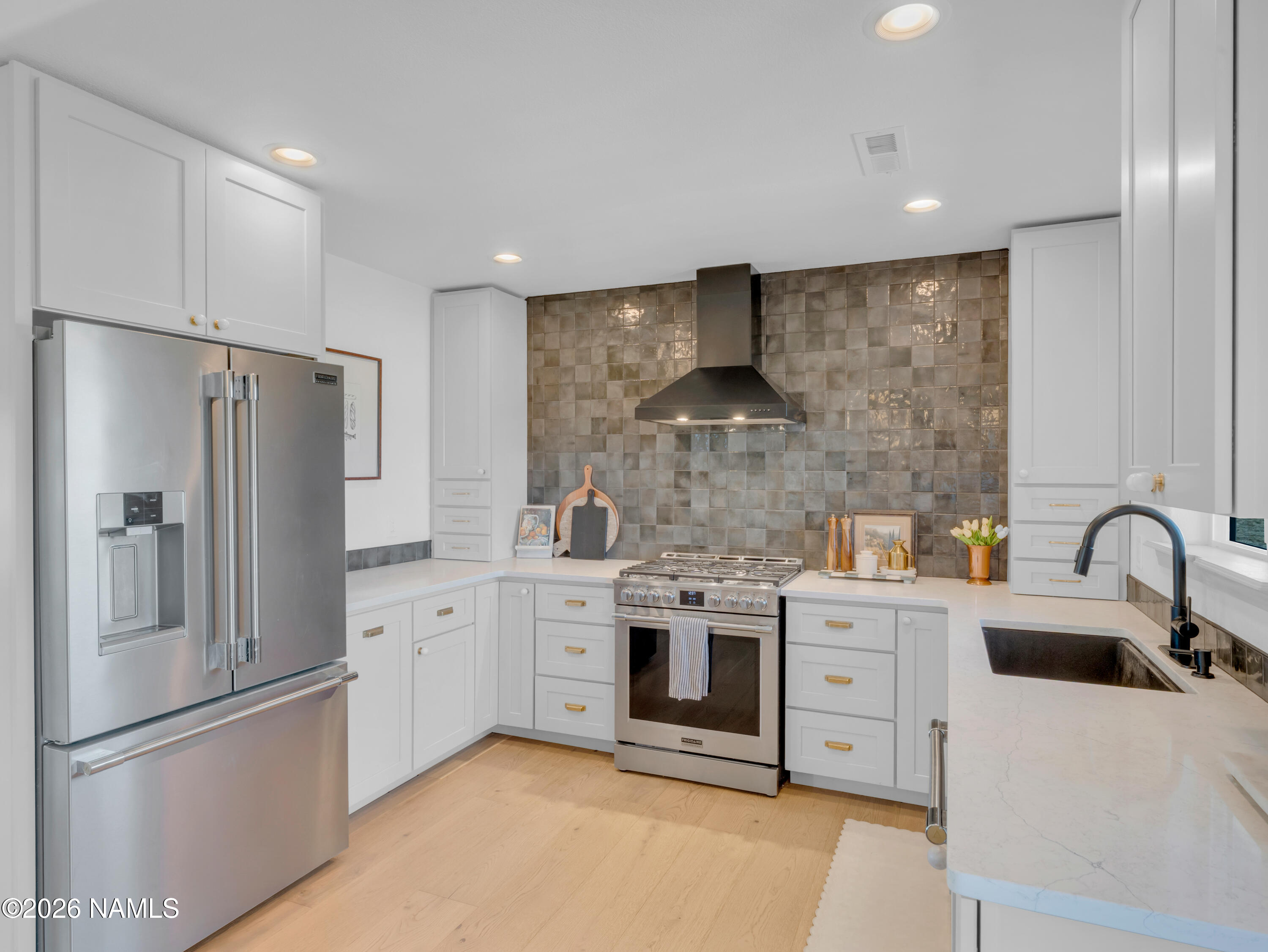 8115 Fawn Run Road Flagstaff, AZ 86004 - Photo 6 of 26 a kitchen with stainless steel appliances a refrigerator sink and cabinets