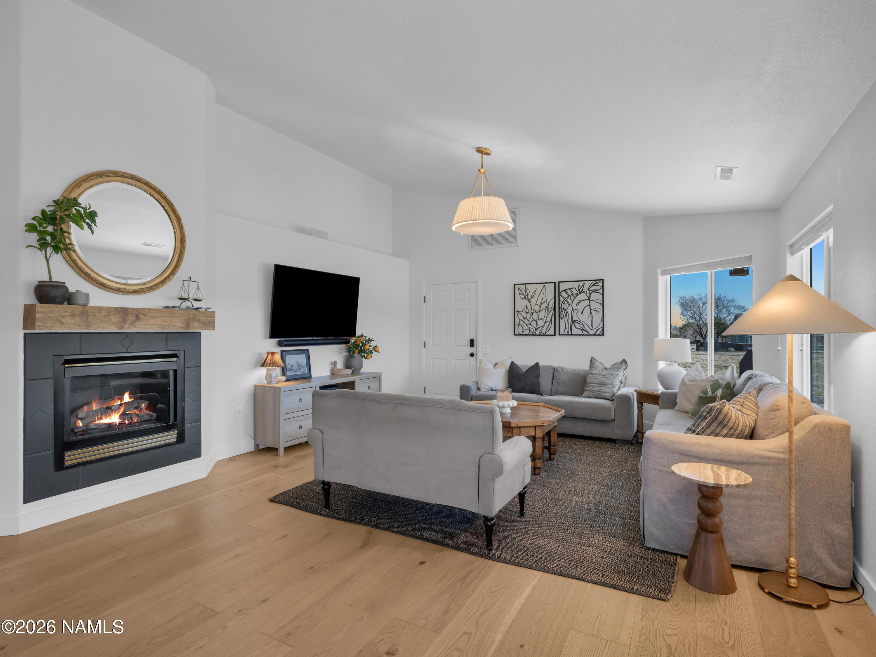 8115 Fawn Run Road Flagstaff, AZ 86004 - Photo 8 of 26 a living room with furniture a fireplace and a flat screen tv