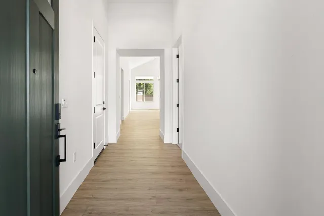 a view of a hallway with the wooden floor