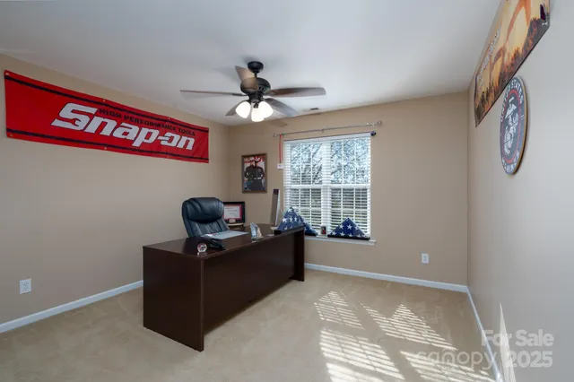a view of a livingroom with workspace and a window