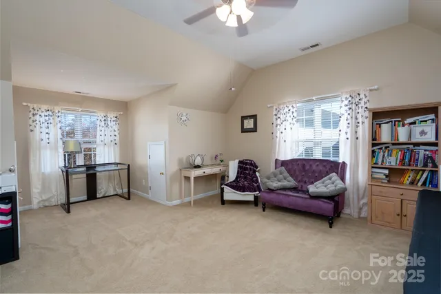 a living room with furniture and a book shelf