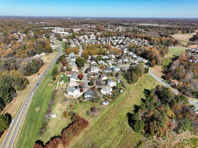 an aerial view of residential house with outdoor space and swimming pool