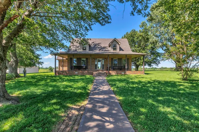 a front view of a house with yard