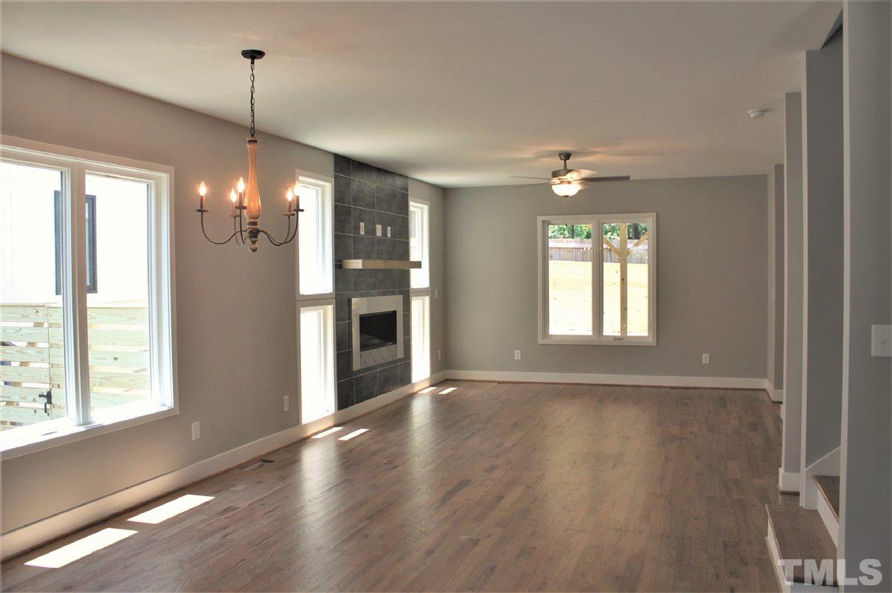 202 Parrish Street Raleigh, NC 27610 - Photo 5 of 14 Living room enhanced by so much natural light and looking out to the fabulous covered outdoor living space.