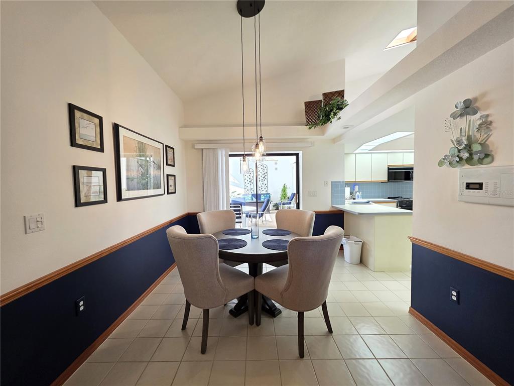 9446 Ashley Drive Weeki Wachee, FL 34613 - Photo 11 of 45 a dining room with furniture and window