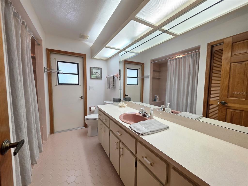 9446 Ashley Drive Weeki Wachee, FL 34613 - Photo 19 of 45 a bathroom with a sink a vanity and a large mirror