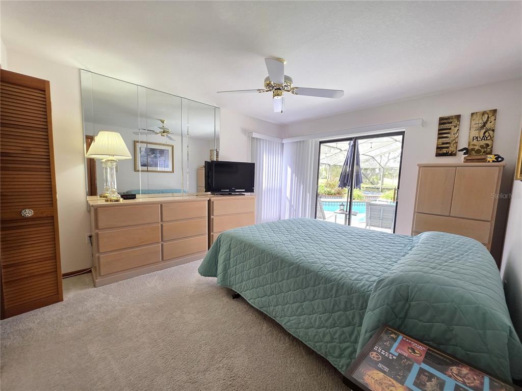 9446 Ashley Drive Weeki Wachee, FL 34613 - Photo 20 of 45 a bedroom with a bed and a television