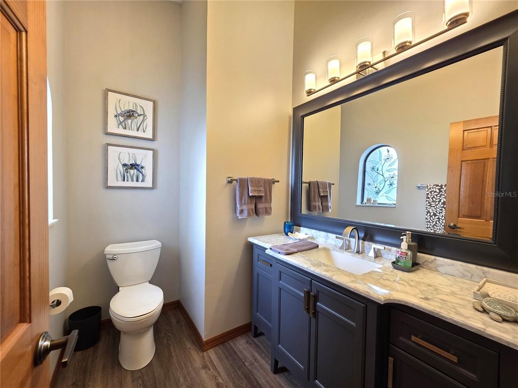 9446 Ashley Drive Weeki Wachee, FL 34613 - Photo 25 of 45 a bathroom with a toilet a sink and a mirror