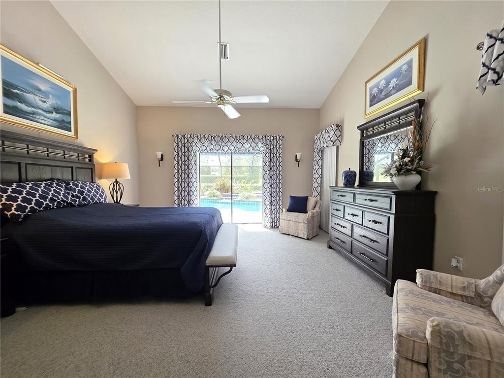 9446 Ashley Drive Weeki Wachee, FL 34613 - Photo 31 of 45 a spacious bedroom with a bed dresser and a window