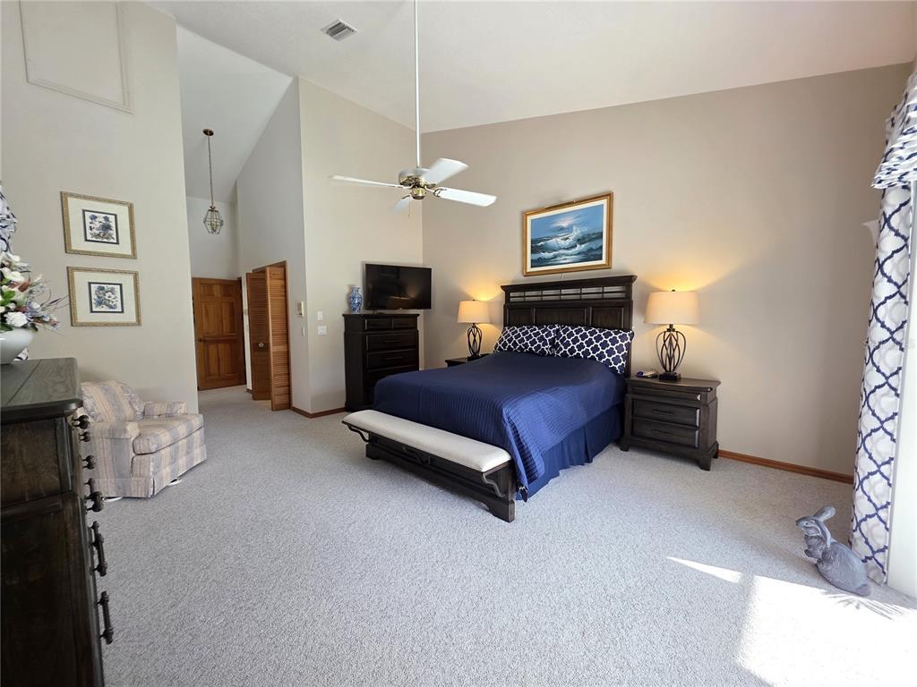 9446 Ashley Drive Weeki Wachee, FL 34613 - Photo 32 of 45 a bedroom with furniture and a chandelier