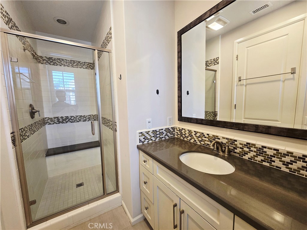 101 Newall Irvine, CA 92618 - Photo 16 of 24 a bathroom with a granite countertop sink and a mirror