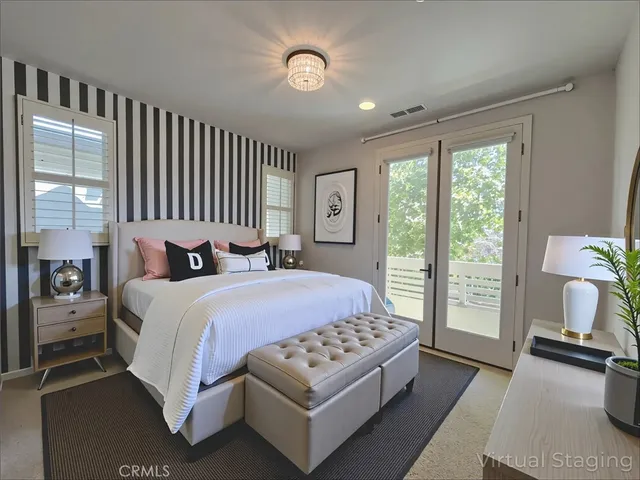 a bedroom with a bed lamp and a large window