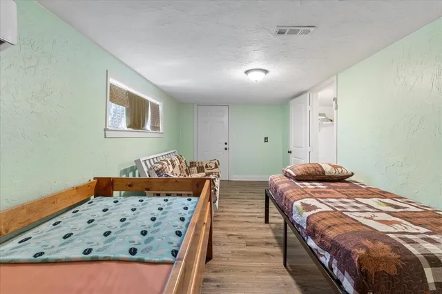 a bedroom with bed and window