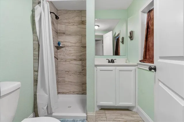 a bathroom with a shower and a sink