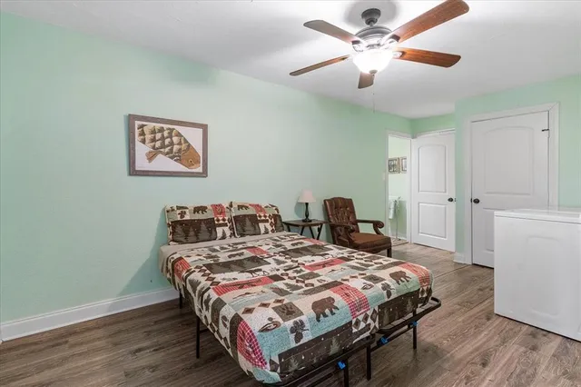 a bedroom with a bed and a chandelier