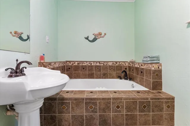 a bathroom with a bathtub and a sink