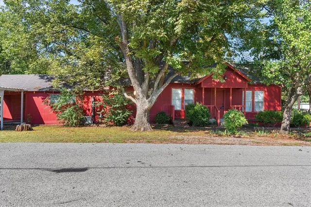 a front view of a house with a yard and a garage