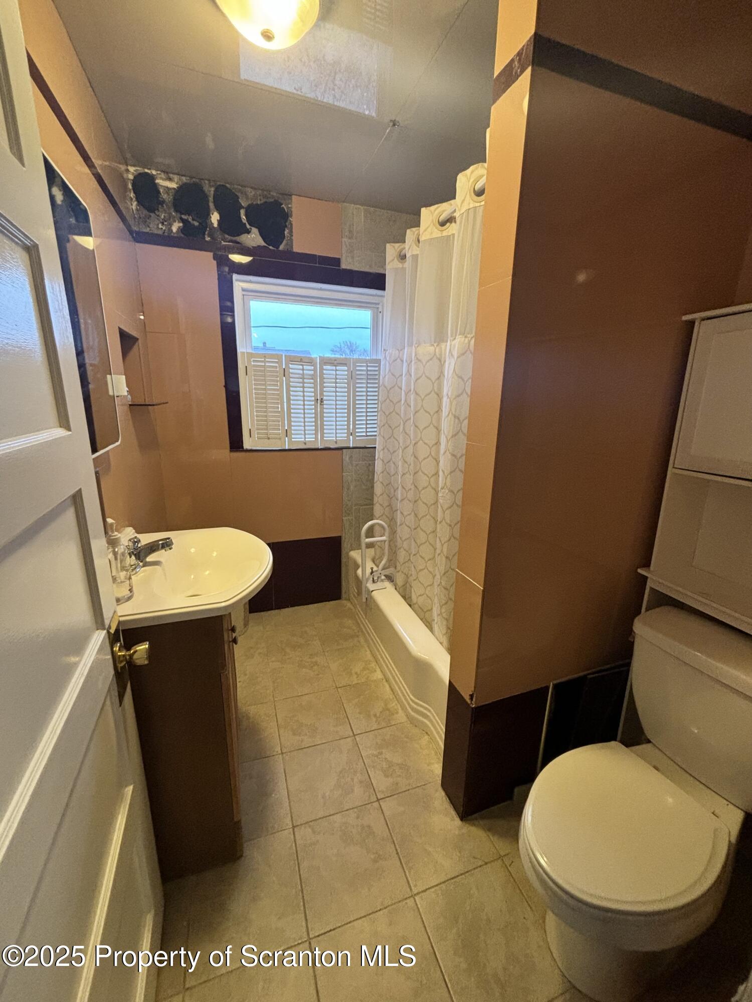 1625 Clay Avenue Dunmore, PA 18509 - Photo 14 of 17 a bathroom with a sink a toilet a mirror and shower