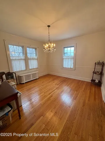 a view of a room with wooden floor and windows