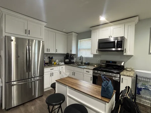 a kitchen with a refrigerator stove and microwave