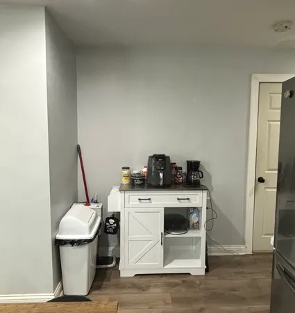 a view of a kitchen with a stove wooden floor and a window