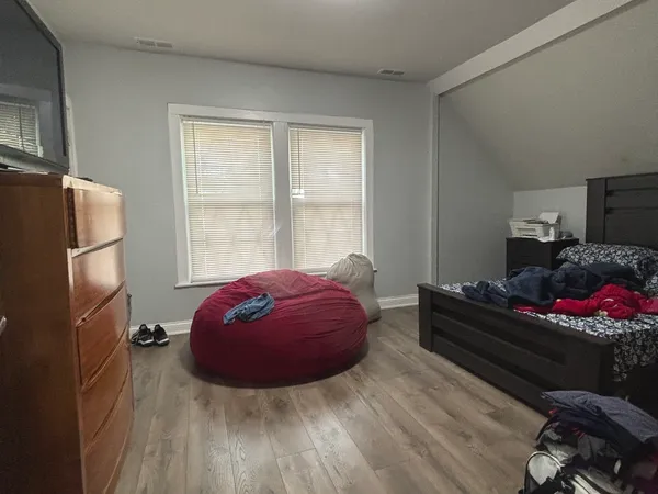 a bedroom with a bed and a window