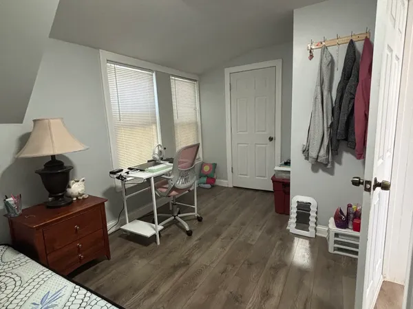 a living room with furniture a flat screen tv and a window