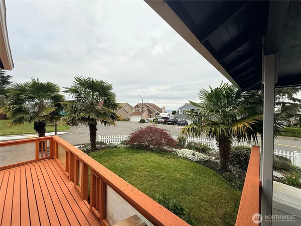 a view of balcony with a garden and trees