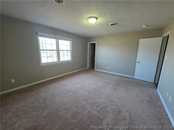 an empty room with a empty space and windows