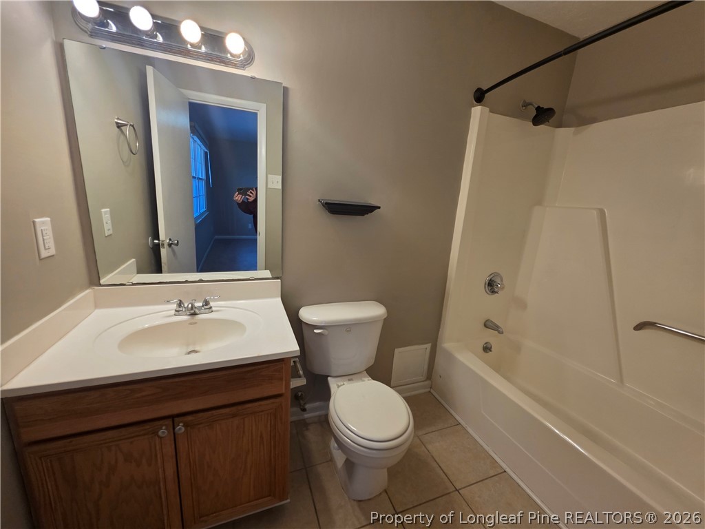 6536 Grist Mill Road Fayetteville, NC 28314 - Photo 19 of 23 a bathroom with a sink a toilet and shower