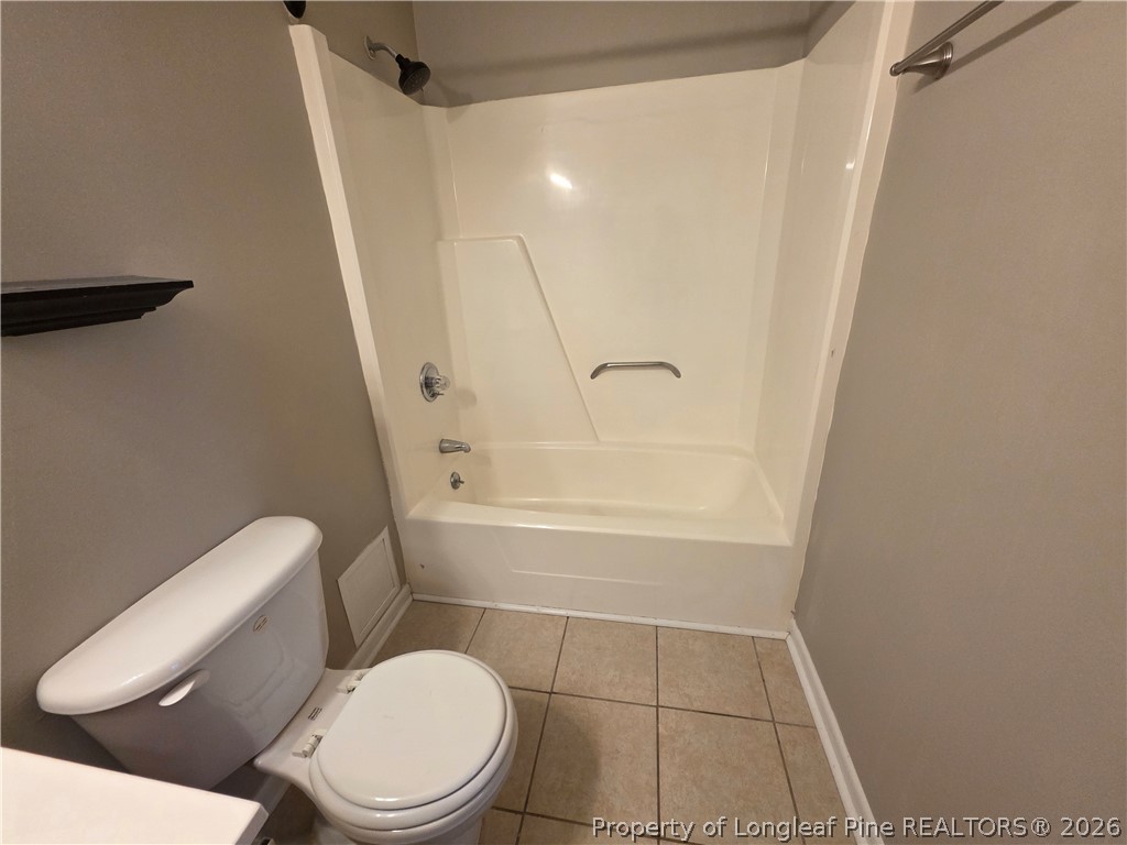 6536 Grist Mill Road Fayetteville, NC 28314 - Photo 21 of 23 a white toilet sitting next to a bath tub