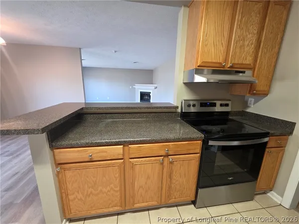 a stove top oven sitting inside of a kitchen