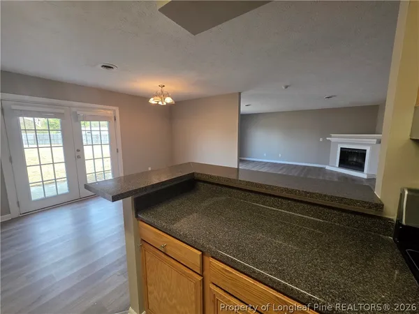 a kitchen with a sink and wooden floor