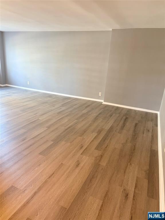 280 South Prospect Avenue, Unit 3N Hackensack, NJ 07601 - Photo 7 of 24 a view of an empty room with wooden floor