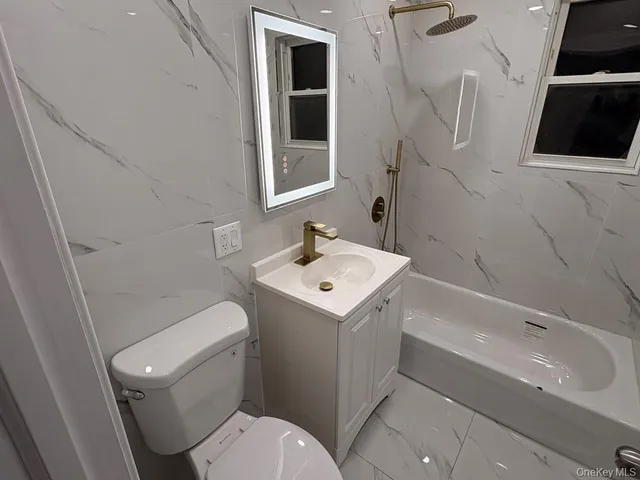 a white toilet sitting next to a bathroom sink