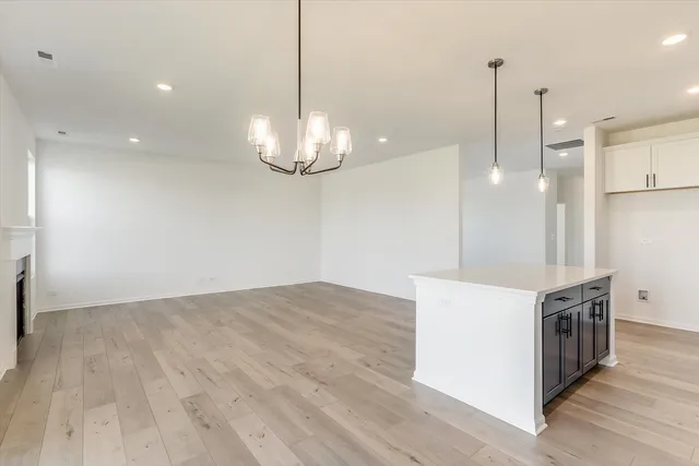 a view of a kitchen with a stove kitchen island and wooden floor