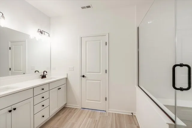 a bathroom with a double vanity sink and mirror