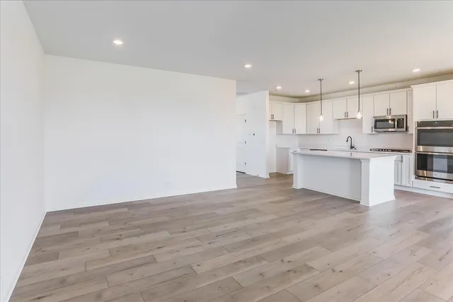 a view of kitchen with wooden floor and electronic appliances