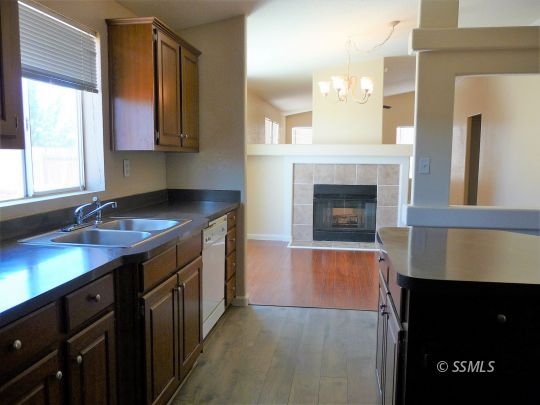 770 Alpine Way Ridgecrest, CA 93555 - Photo 19 of 50 a kitchen with cabinets and a fireplace