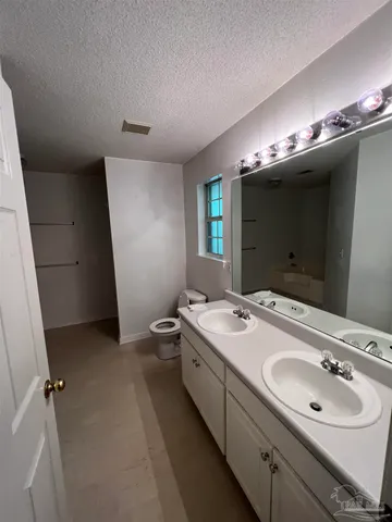 a bathroom with a double vanity sink and mirror