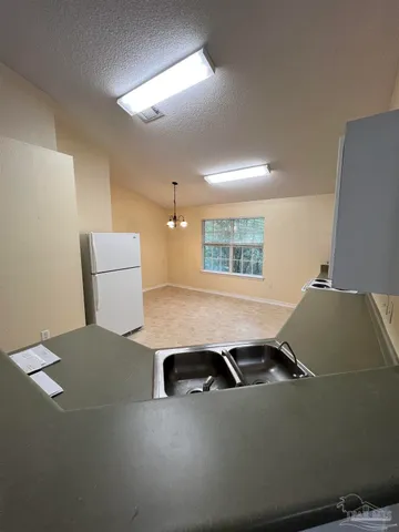 a room with furniture and a air conditioner vent