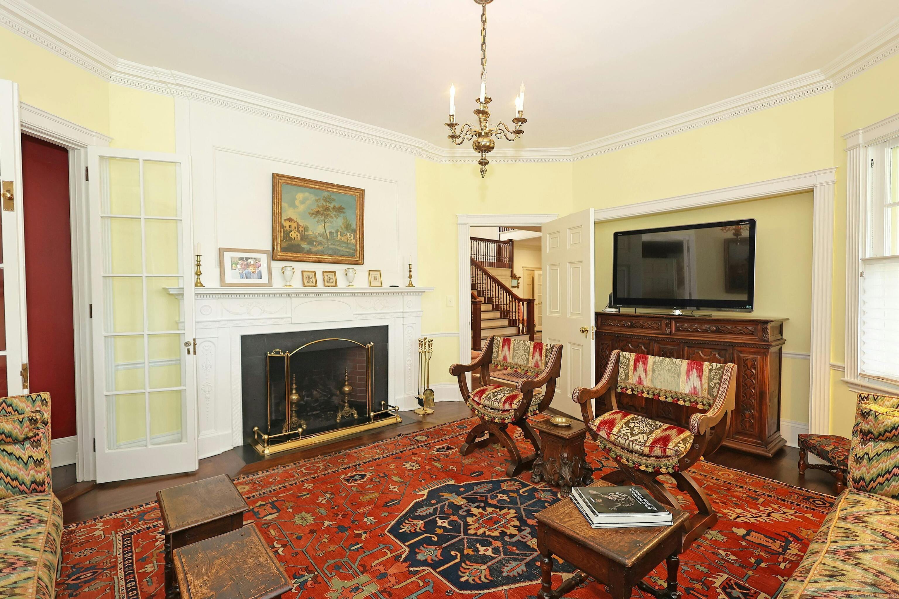 27 Country Club Road Ridgefield, CT 06877 - Photo 17 of 40 a living room with furniture a flat screen tv and a fireplace