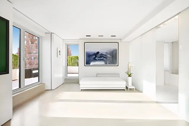 a bedroom with a bed and view of bathroom