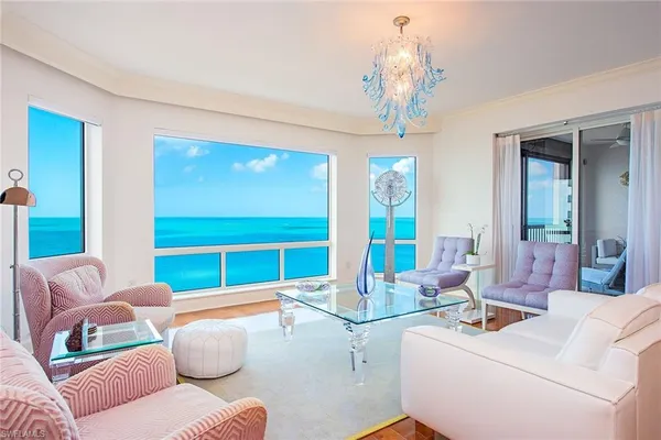 a living room with furniture and a chandelier