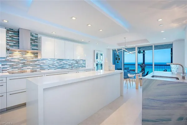 a view of kitchen with stainless steel appliances granite countertop sink and cabinets