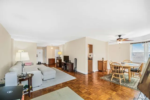 a living room with furniture kitchen view and a table