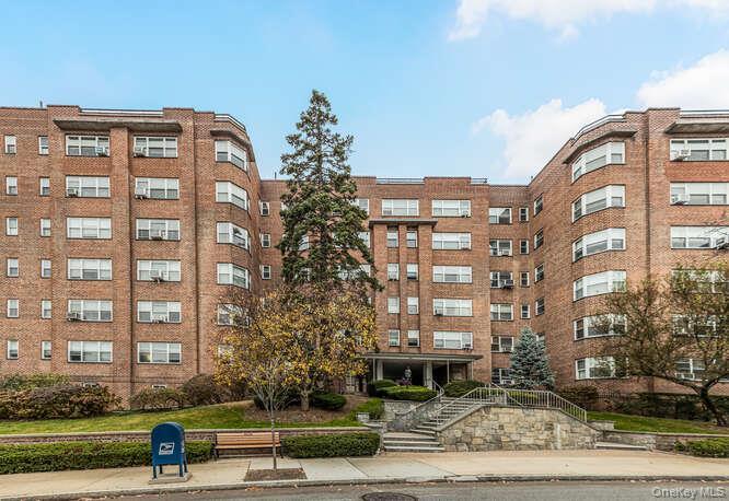 235 Garth Road, Unit E5I Scarsdale, NY 10583 - Photo 19 of 22 a view of a building with a yard