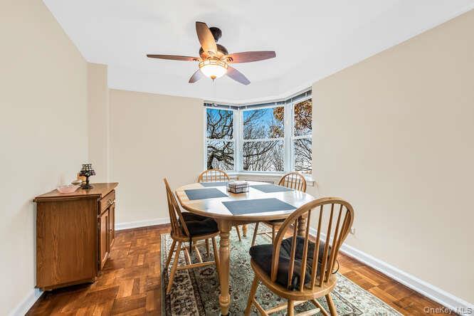 235 Garth Road, Unit E5I Scarsdale, NY 10583 - Photo 2 of 22 a view of a dining room with furniture and wooden floor